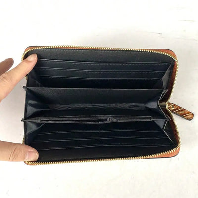 Long wallet with carved pattern and zip-around closure for women