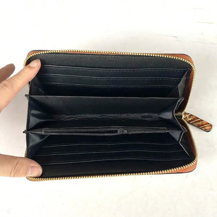 Long wallet with carved pattern and zip-around closure for women