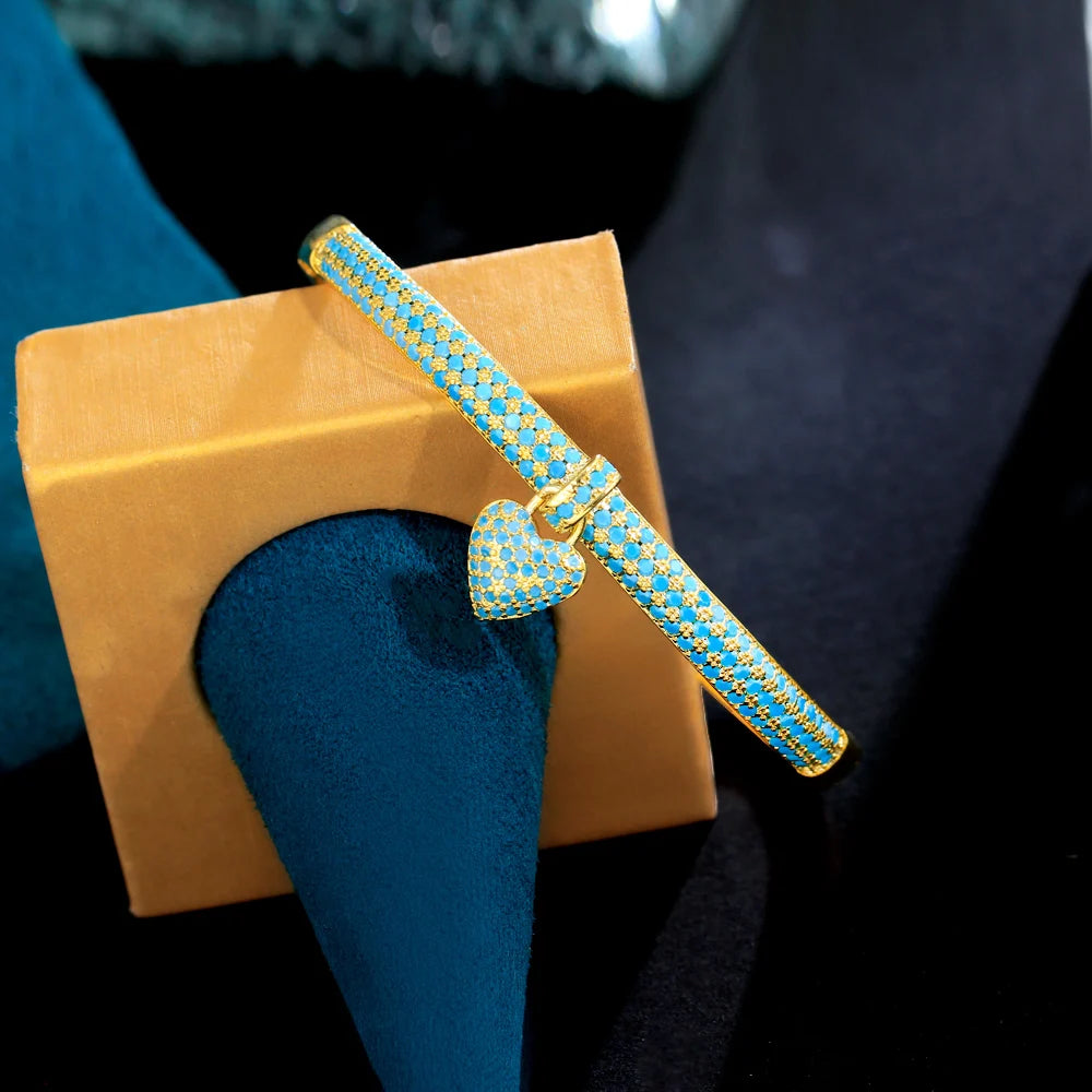 Gold-tone bangle with heart charm and blue cubic zirconia for women